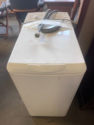 a white refrigerator sitting in the middle of a room