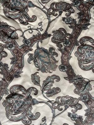 an image of a close up of a bed with a floral pattern on it