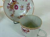 two cups and a saucer sitting on a table