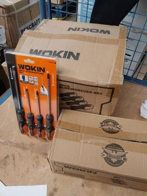many boxes of tools sitting on a table in a room