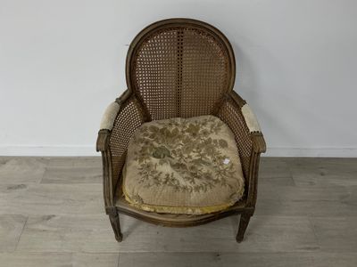 une vieille chaise avec un coussin dessus, dans une pièce