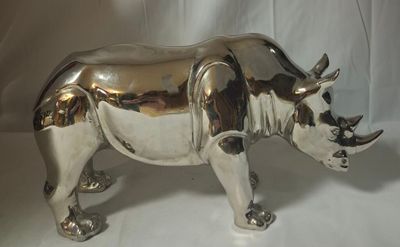 a silver rhino statue on a white background
