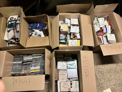 several boxes of books are stacked on the floor with writing on them