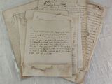 several old letters are stacked on top of each other on a sheet of paper