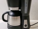 a coffee maker and a coffee pot on a table