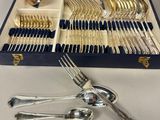 an assortment of silverware in a box with a spoon and fork