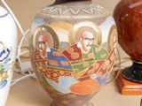 two vases that have been decorated with pictures of people on them
