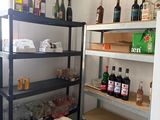 many bottles of alcohol on the shelves in the kitchen