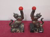 pair of cat bookends on marble bases with red balls