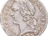 gros plan d'une pièce de monnaie sur laquelle figure une tête de femme