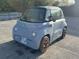 a small car that is parked in a parking lot