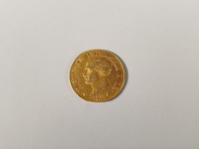 a close up of a gold coin on a white surface