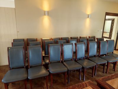 many chairs in a room with a mirror on the wall