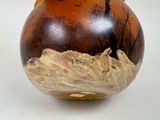 a brown vase with a tree on it sitting on a table
