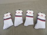 three pairs of white socks with red, white and blue stripes