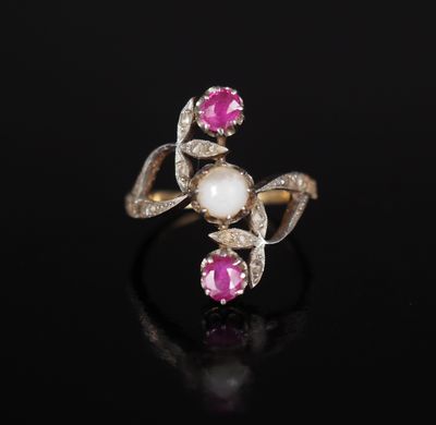 a close up of a pink and white pearl ring on a black surface