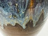 a vase that is sitting on a stand on a table