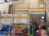 a forklift in a warehouse with a sign on the wall