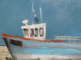 a painting of a boat on display on the wall