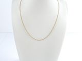 a gold chain necklace on a mannequin head
