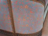 a bed that has a blue and pink cover on it