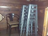 a stack of stools and a chair in a room