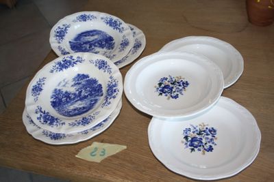 four plates on the table with blue flowers on them