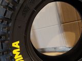 a tire with a yellow sticker on the side of it