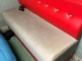a red bench with a blue chair next to it
