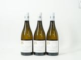 trois bouteilles de vin posées sur une table l'une à côté de l'autre