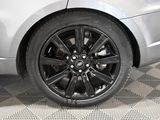 a close up view of a car ' s wheel on a checkered floor