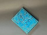 a small blue box with a design on it