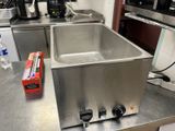 a stainless steel sink in the middle of a kitchen