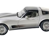 a silver car that is sitting on a white surface