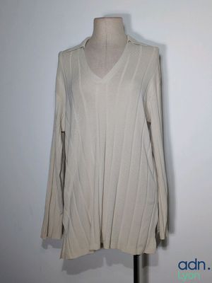 a white shirt on a mannequin stand with a white background