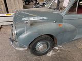 an old car that is sitting in a garage