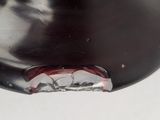 a close up of a metal object with a toothbrush in it