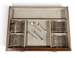 a wooden tray with silverware in it on a white surface