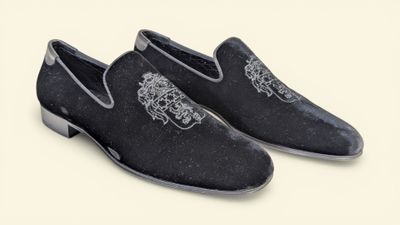 men ' s black velvet slippers with a lion on the front