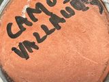 a brown cake with black writing on the top of it
