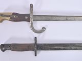 two knives that are on a white surface