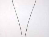 a necklace with a brown pearl hangs on a silver chain