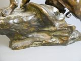 a bronze statue of a man riding a horse on a rock
