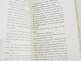 a person holding a book open on a table