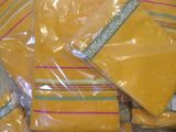 a pile of yellow napkins wrapped in plastic bags