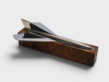 a knife that is sitting on top of a piece of wood