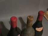 several bottles of wine are lined up on a counter