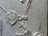 a relief of a man holding a sword and a shield