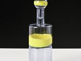 a glass bottle with a lemon inside of it on a table