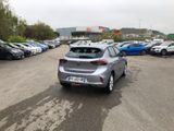 a silver car parked in a parking lot next to other cars